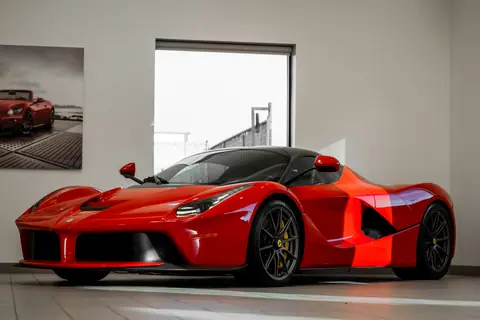 Red Ferrari supercar in a showroom