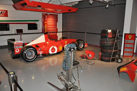 Ferrari F1 car in a pit garage display